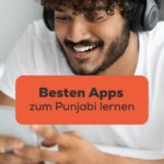 Dunkelhaariger Mann hat schwarze Kopfhörer an und Handy in der Hand und sucht nach den Besten Apps zum Punjabi lernen mit der Ling-App